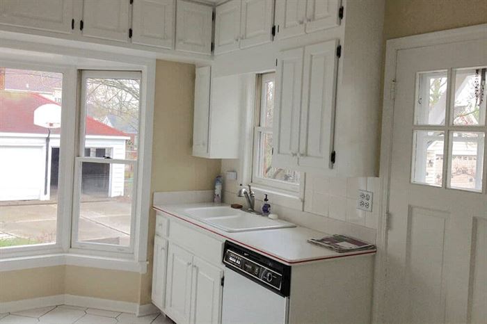 Kitchen dishwasher and cabinets before renovation