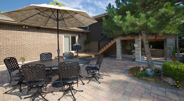 Backyard patio with table and umbrella