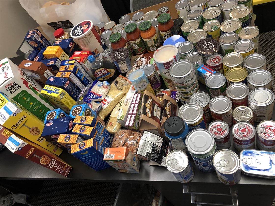 Non-perishable food items on a desk donated for the Northern Illinois Food Bank