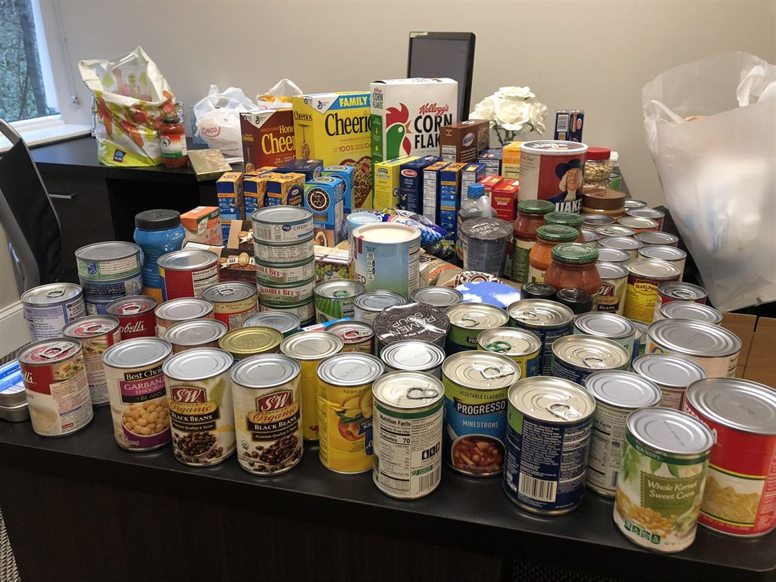 Non-perishable food items on a desk collected for the Northern Illinois Food Bank