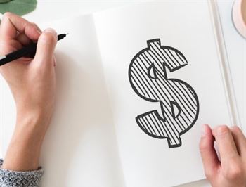 Woman drawing a dollar sign in a notebook
