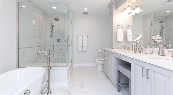 Renovated bathroom with walk-in shower and stand-alone tub
