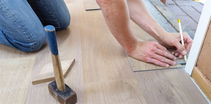 Worker installing new flooring