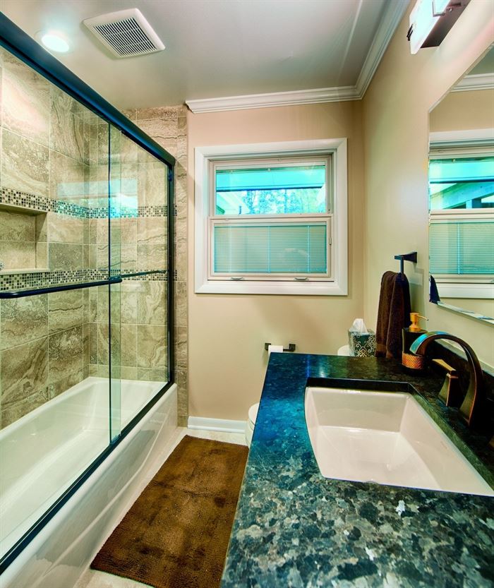 Bathroom with framed shower doors and tub/shower combo