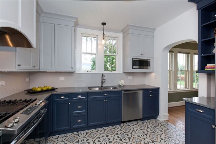 Completed kitchen remodel with blue lower cabinets and white upper cabinets