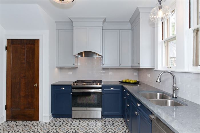 Completed kitchen remodel with blue lower cabinets and white upper cabinets