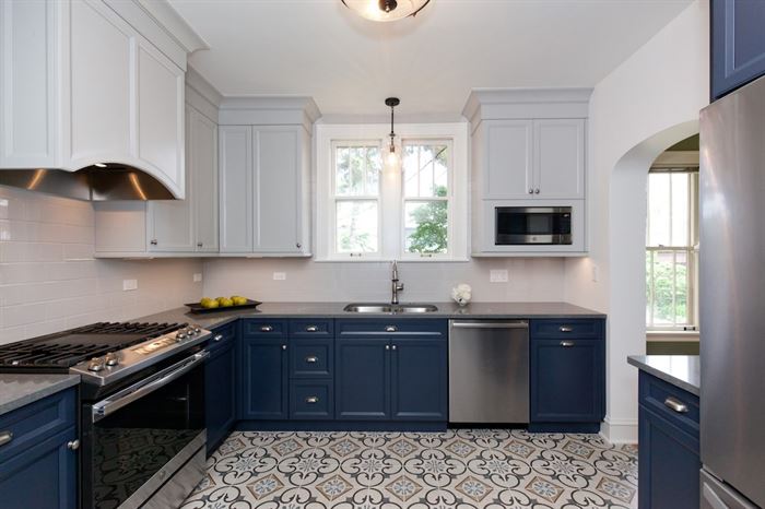 Completed kitchen remodel with blue lower cabinets and white upper cabinets