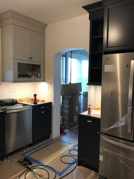 Installation of new stainless steel appliances in kitchen remodel