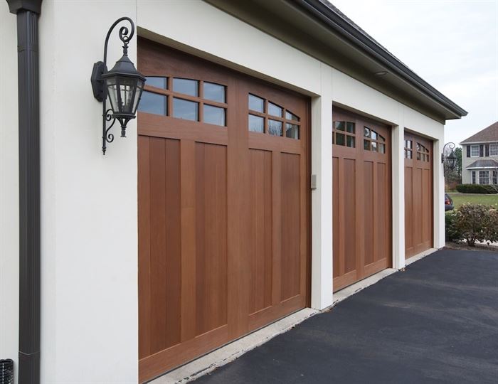 Wood garage doors on white garage