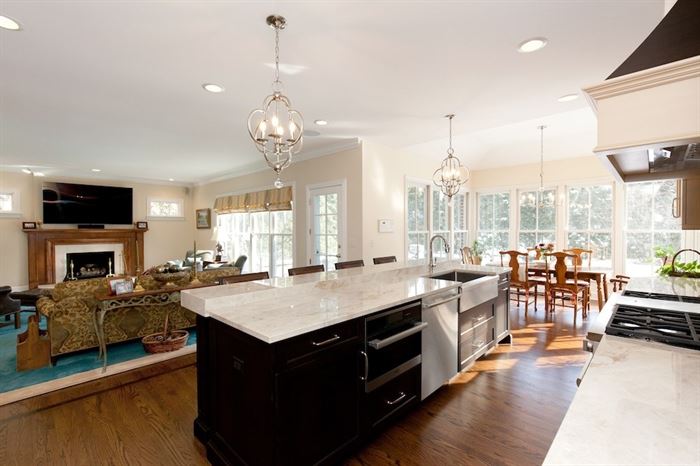 open concept kitchen, living room, dining room with kitchen island in the center