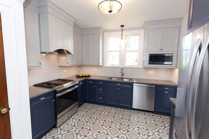 two-toned kitchen with patterned tile floor
