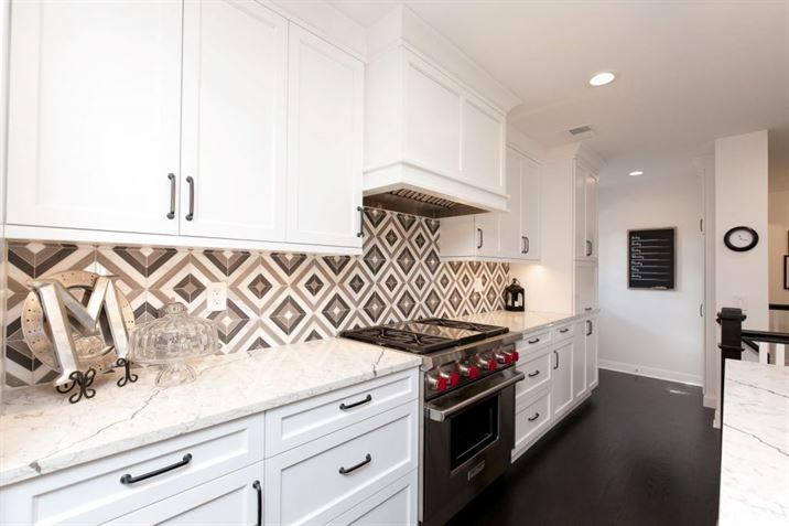 bright white kitchen with patterned backsplash