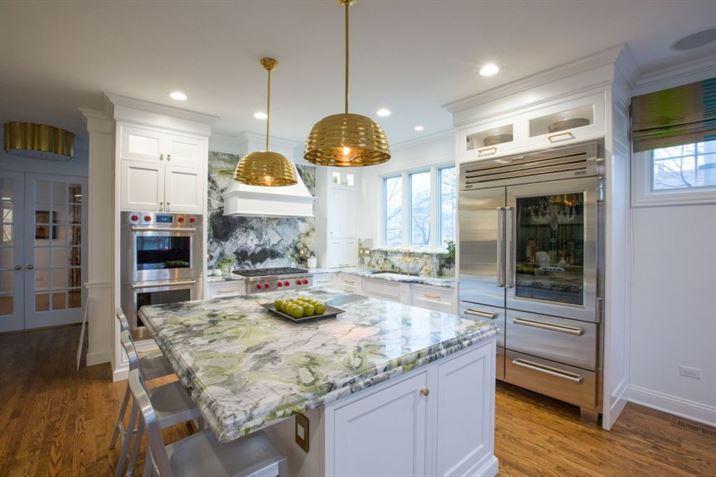modern kitchen with granite backsplash and gold accents